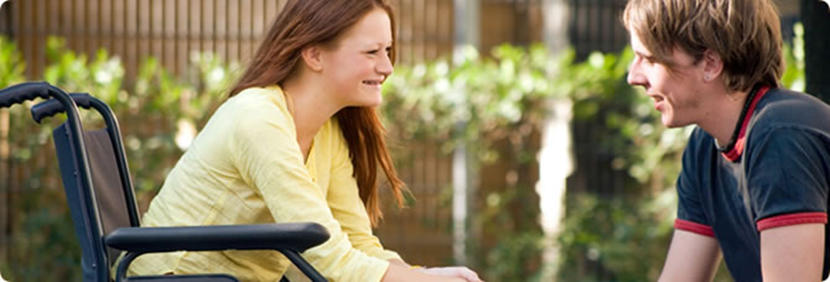 Student on a wheelchair enjoying a conversation with fellow student